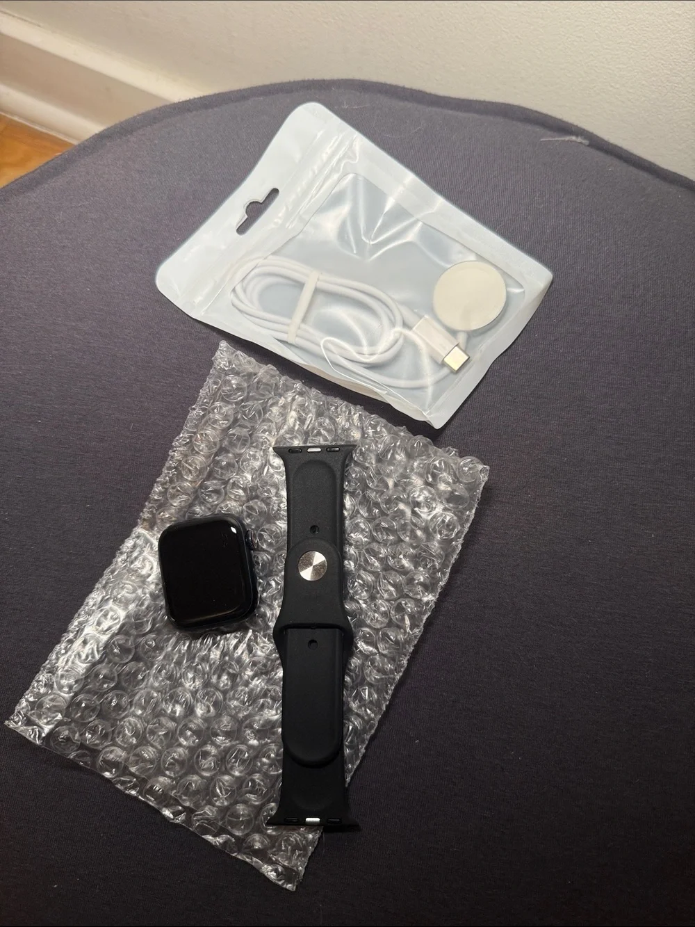 Apple Black Smartwatch with Black Silicone Band and Magnetic Charger Cable